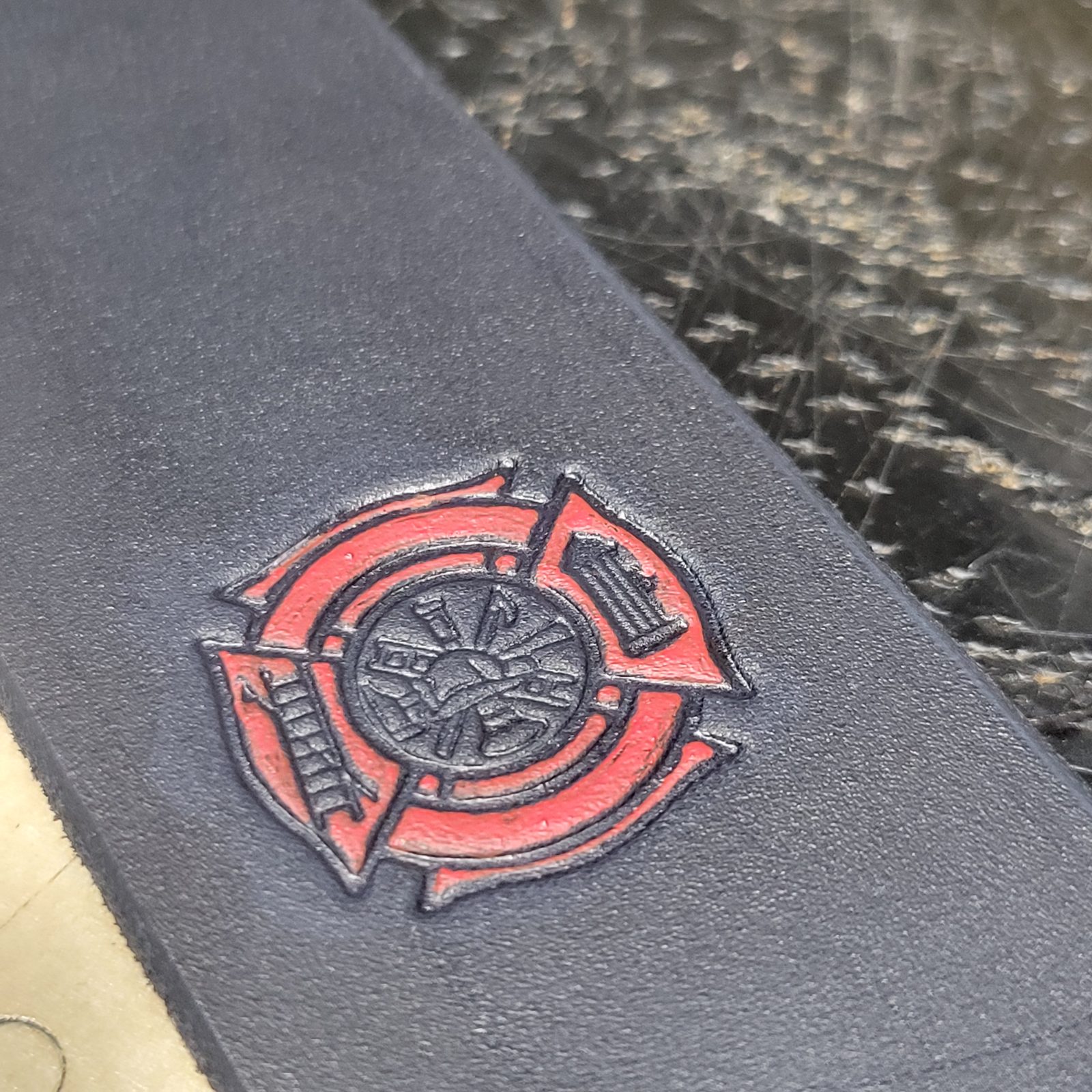 A Maltese cross struck into the leather and painted red