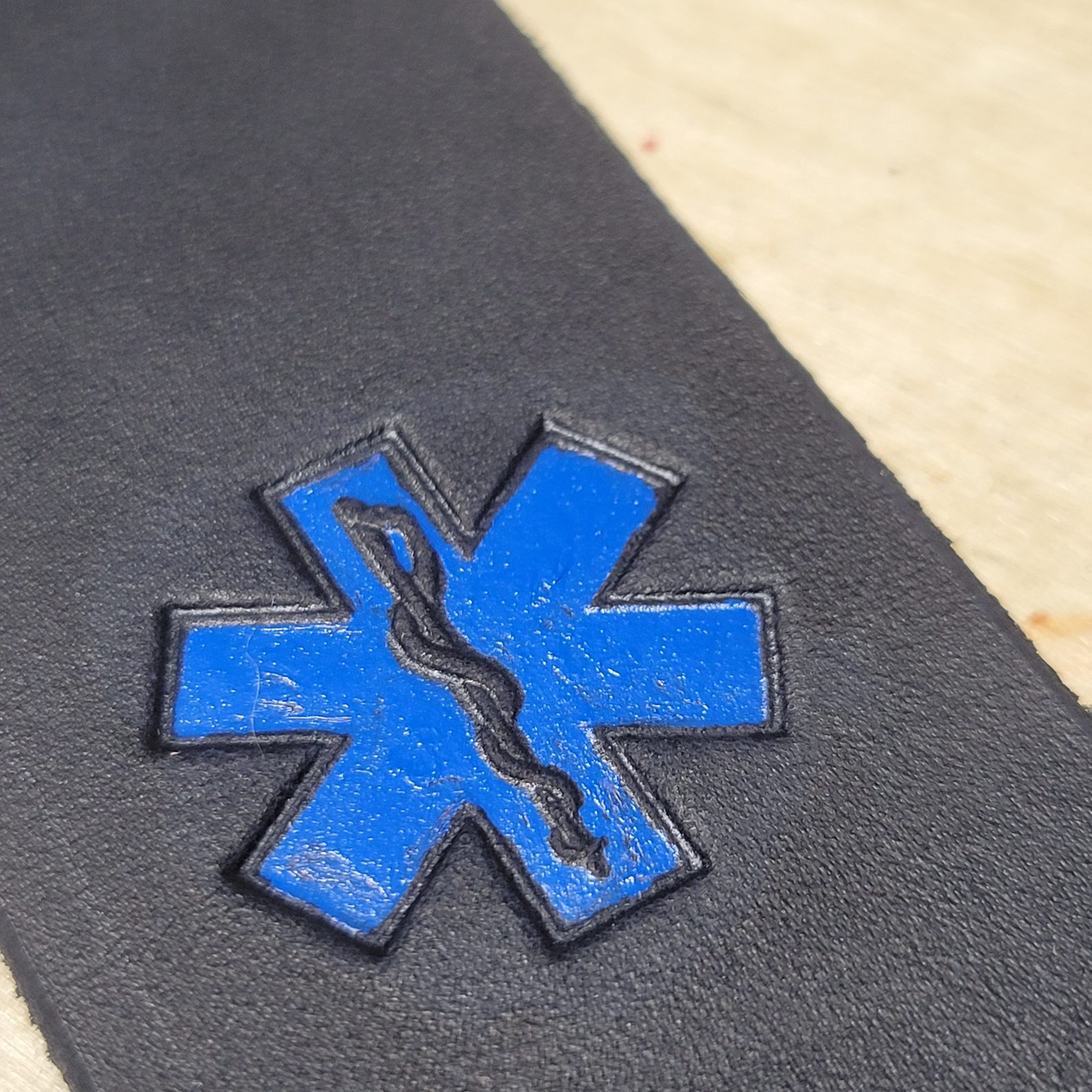 A Star of Life struck into the leather and painted blue